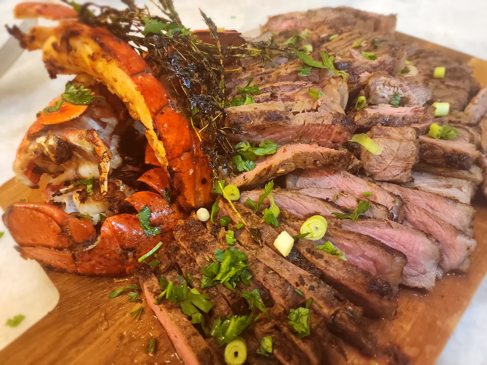 Grilled Surf and Turf — ribeye steak and lemon butter lobster tail